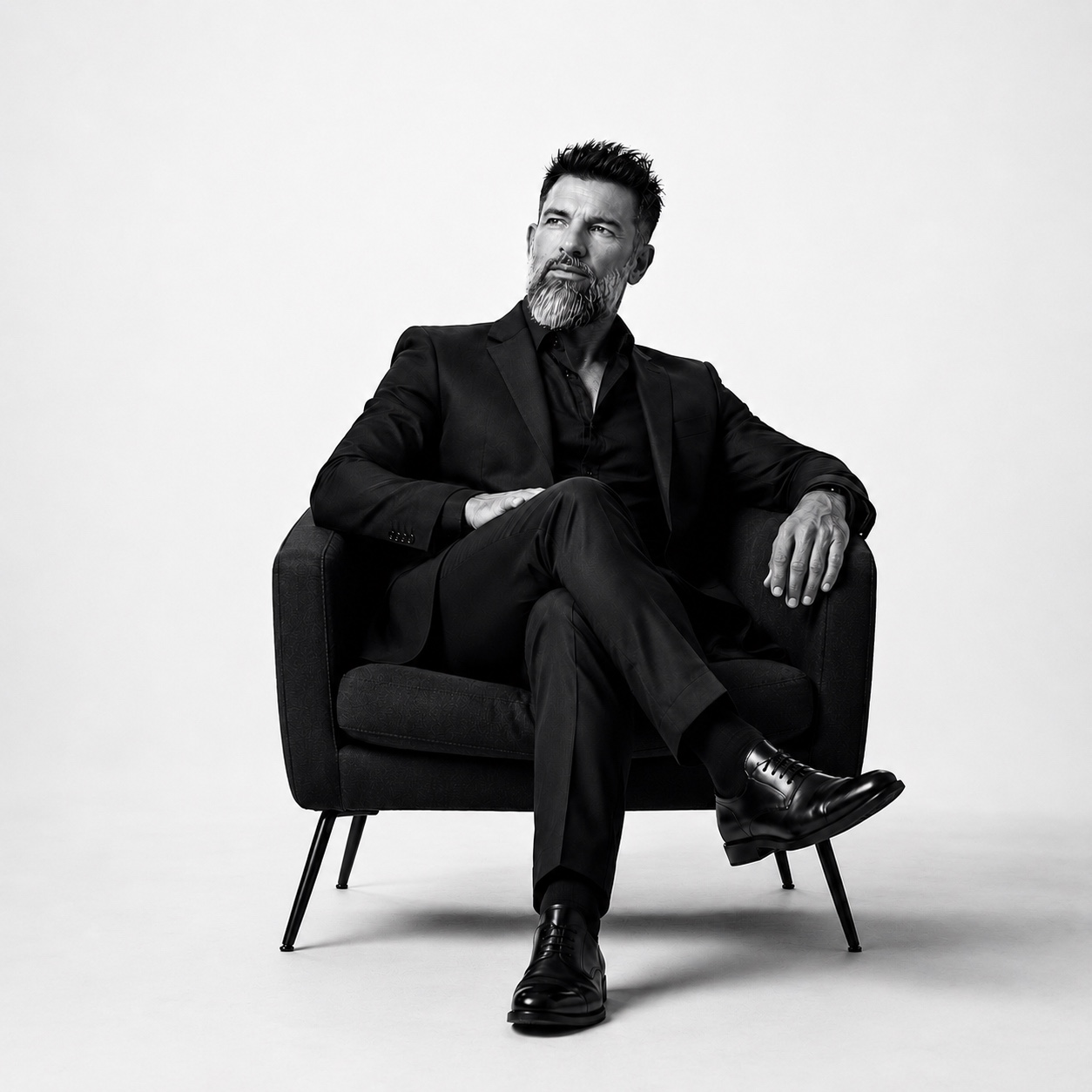 François Dagomet seated in a tailored suit for an editorial portrait