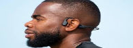 Man wearing a wireless earbud with a clear background